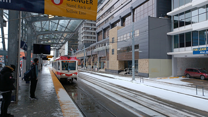 A train pulls into a train station in downtown Calgary in winter